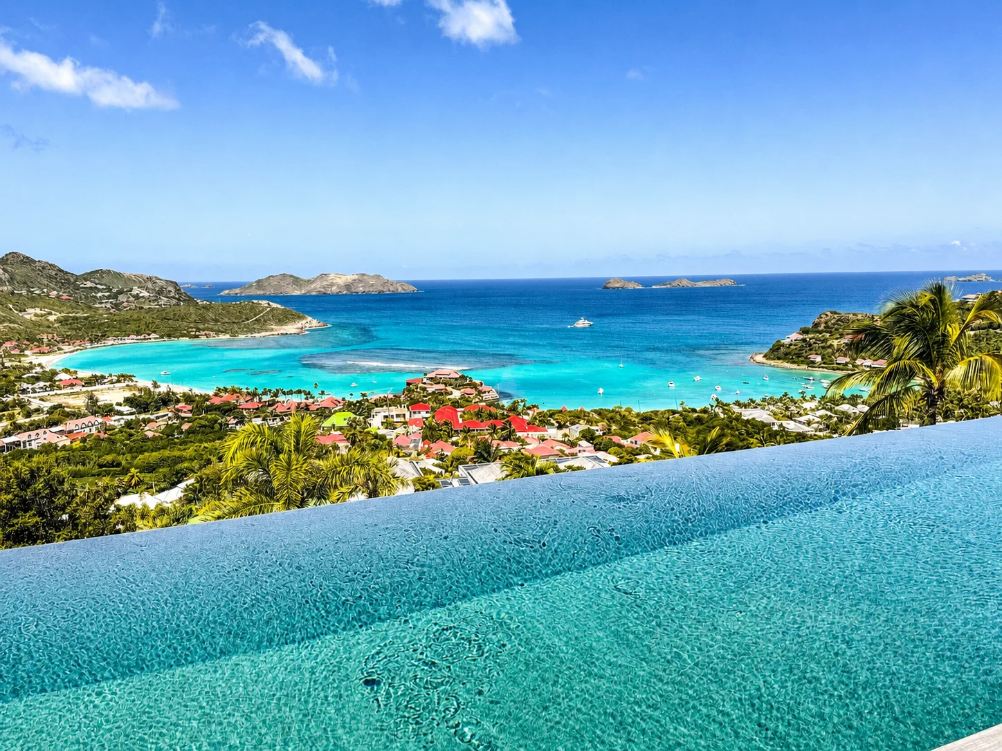 Infinity pool edge dissolving into the turquoise water of St. Jean Bay