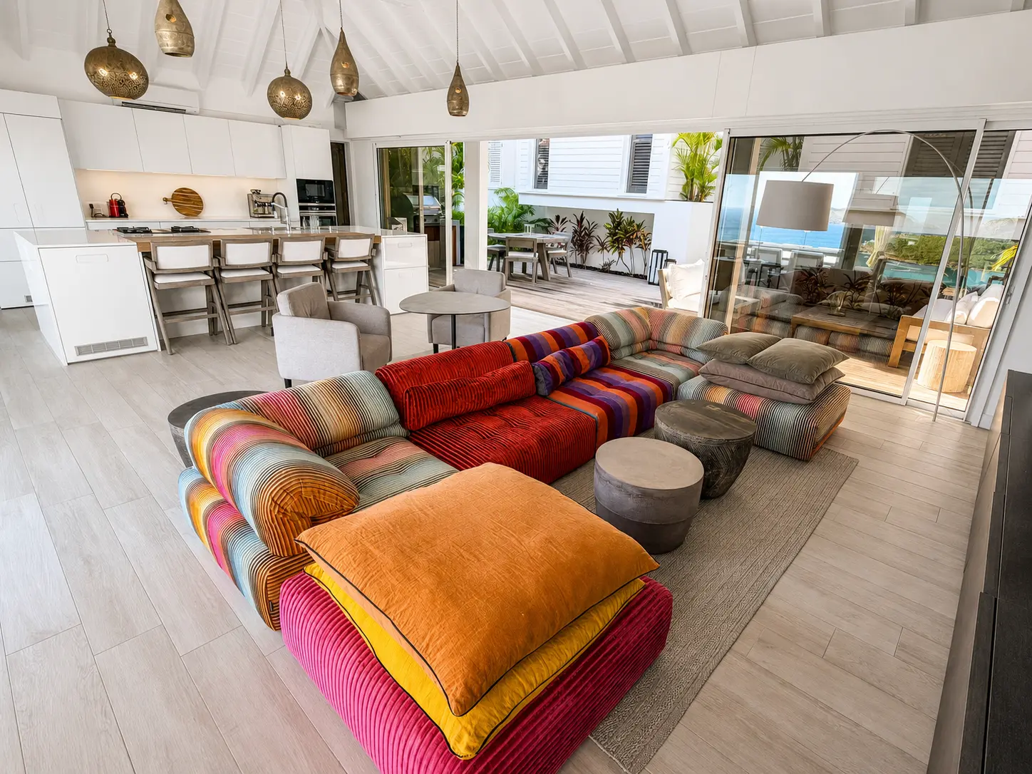 Open-plan living room and kitchen flowing out to the terrace